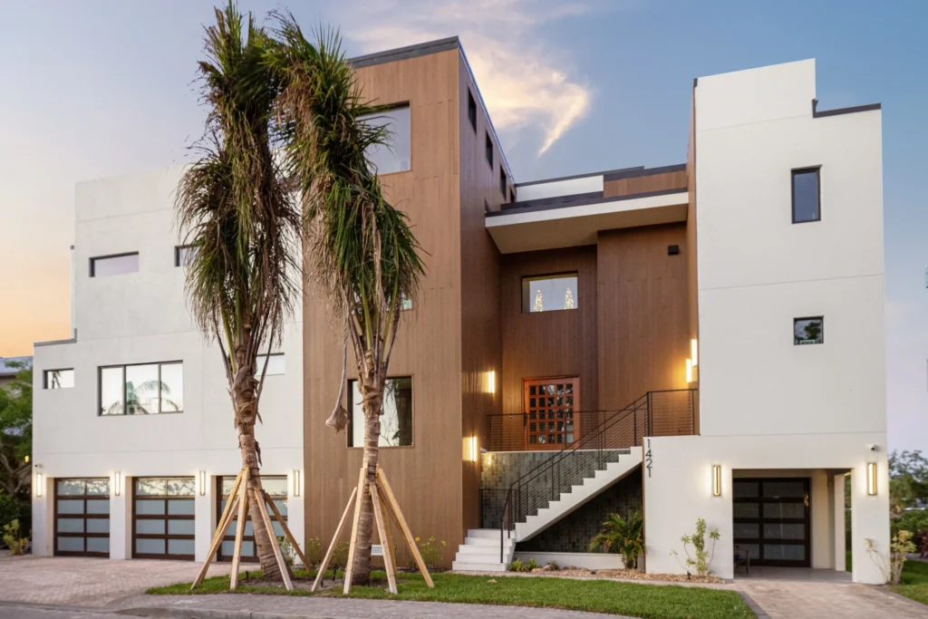 Projects 7 Holliday Group: Modern four-story waterfront custom home in South Sarasota engineered for FEMA V-Zone compliance.