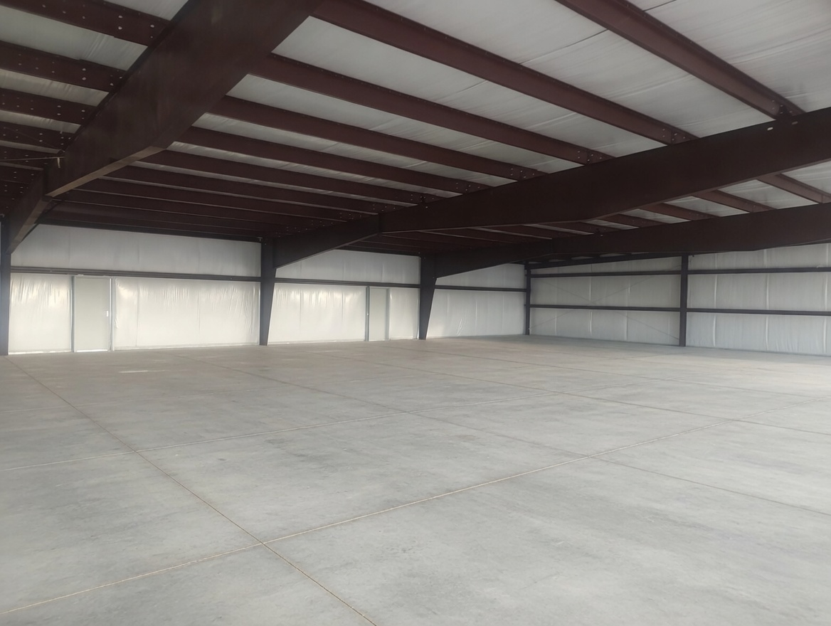 Interior of LeBlanc metal warehouse structure with steel beams and concrete floor built by Holliday Group