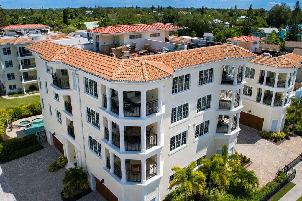 Projects 4 Siesta Key Beach Villas multi-story condominium with white facade and terracotta roof built by Holliday Group